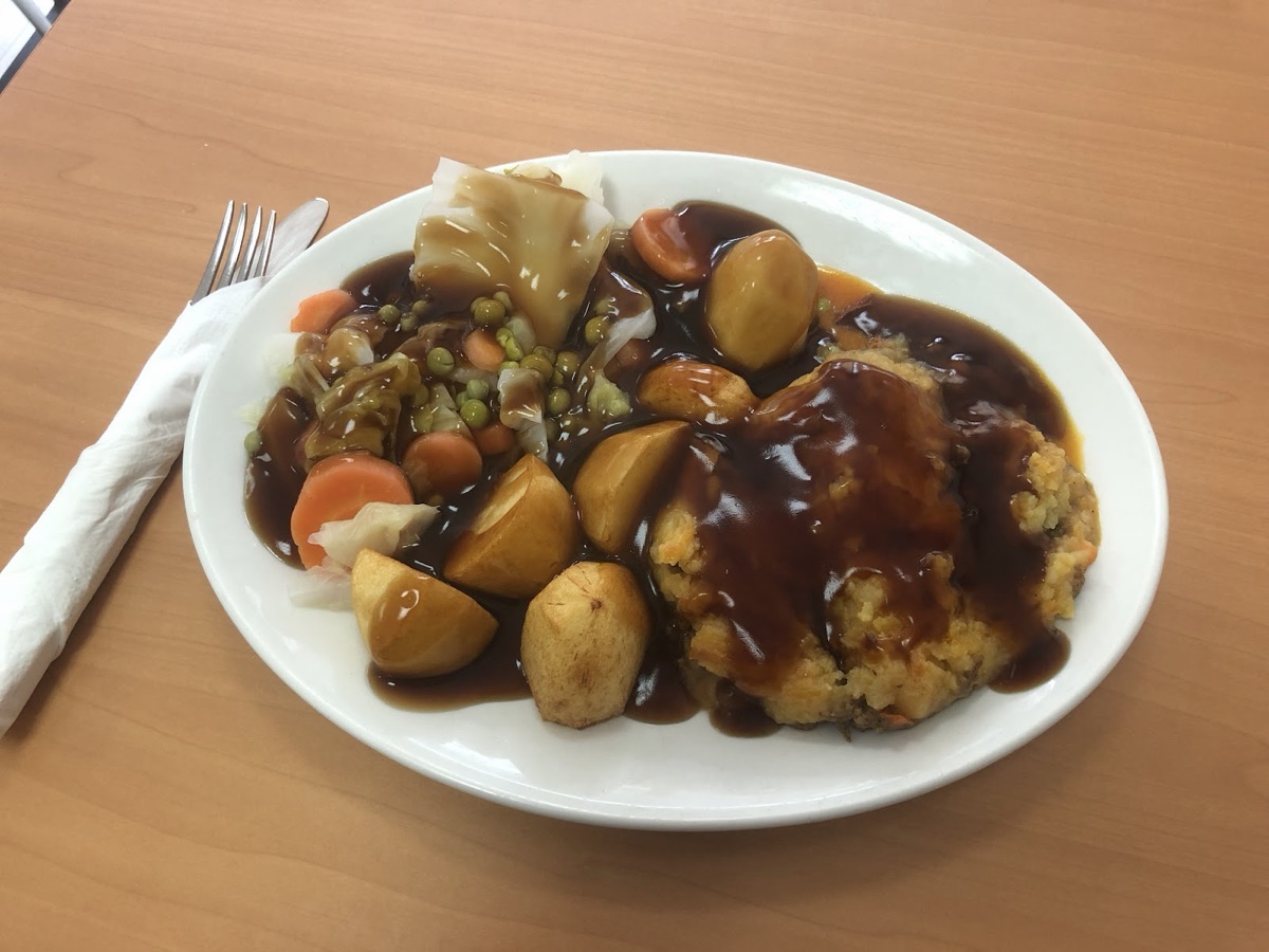 Roast dinner with roast potatoes, vegetables, stuffing and gravy at Plaistow Cafe